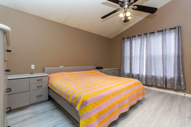 bedroom featuring vaulted ceiling, ceiling fan, and light wood-style flooring