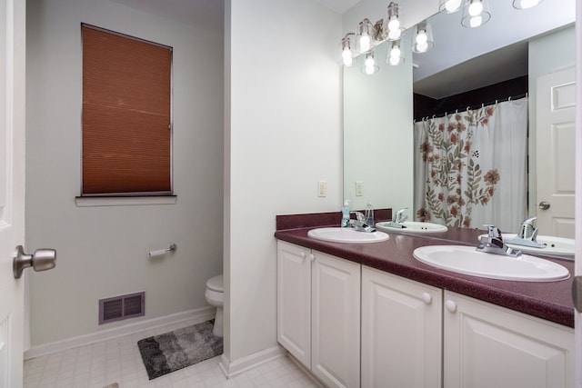 bathroom with visible vents, a sink, toilet, and tile patterned floors