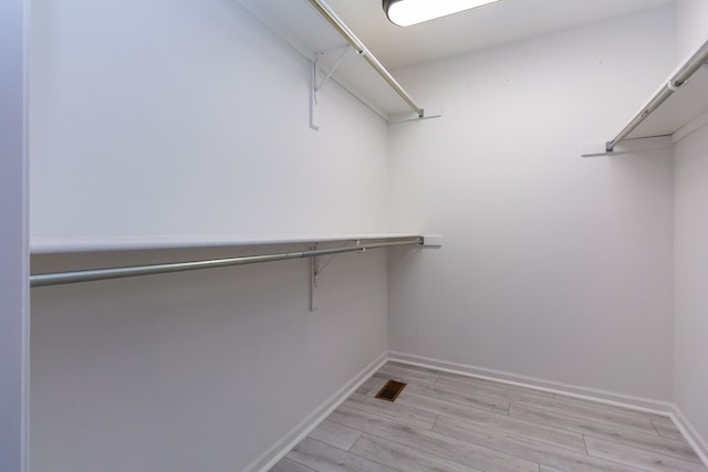 walk in closet featuring light wood-style floors and visible vents