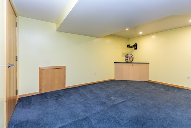 spare room with recessed lighting, dark carpet, and baseboards