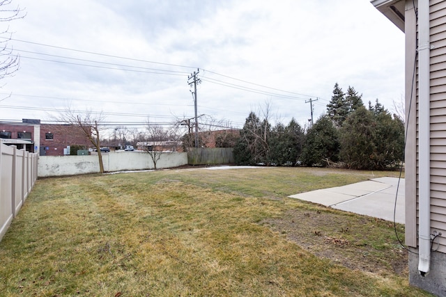 view of yard with fence and a patio