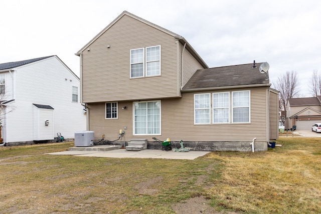 rear view of property with entry steps, a patio area, central AC, and a yard