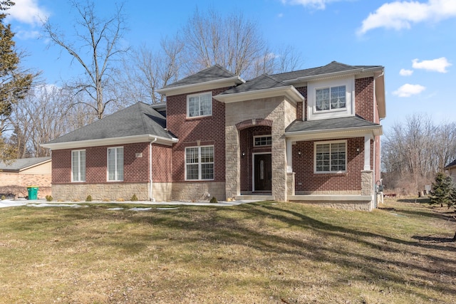 view of front of property with stone siding, brick siding, a front lawn, and roof with shingles