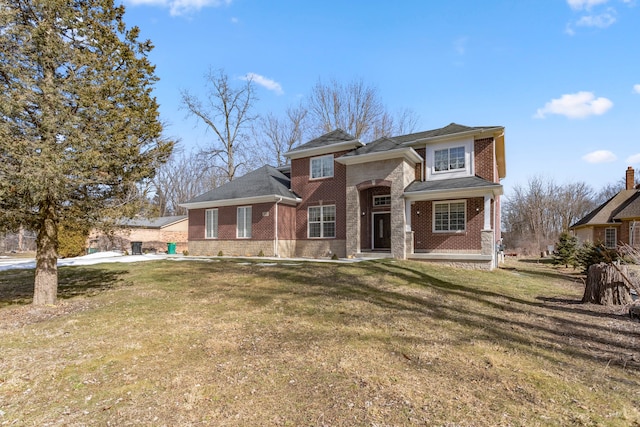 view of front of home with brick siding and a front lawn