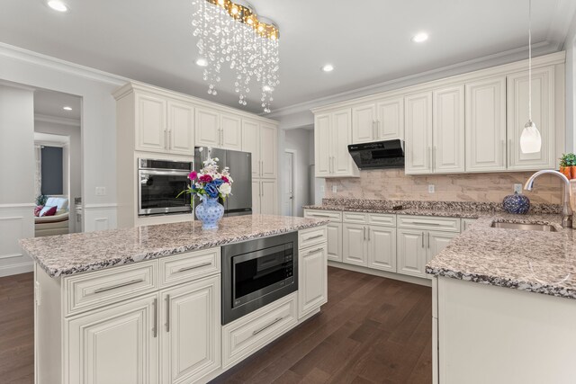 kitchen with extractor fan, dark wood-type flooring, a sink, appliances with stainless steel finishes, and crown molding