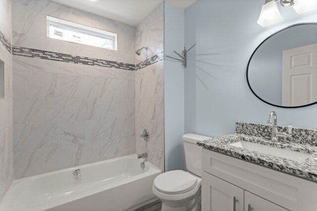 full bath featuring vanity, bathtub / shower combination, and toilet