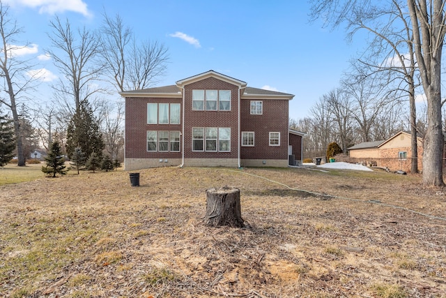 back of property featuring brick siding and crawl space