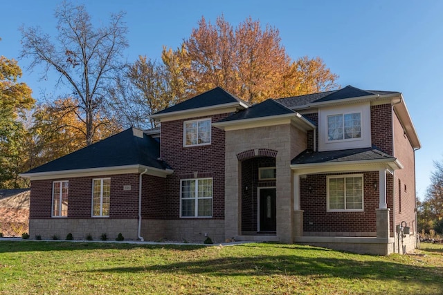 traditional-style house featuring stone siding, brick siding, and a front yard