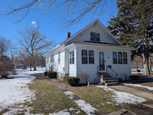 bungalow-style home with a chimney