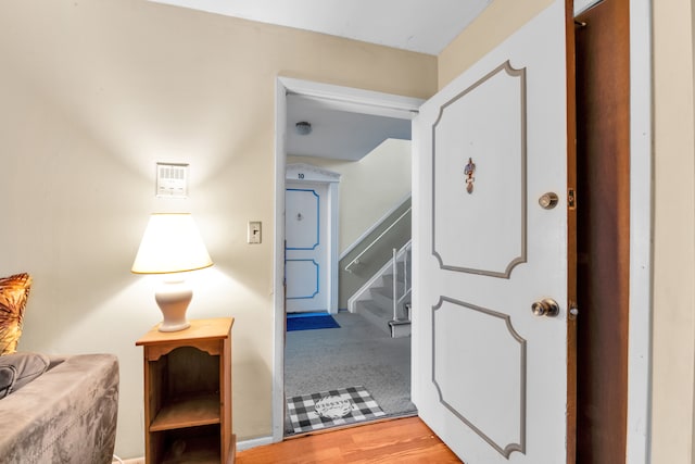 hallway with stairs and wood finished floors