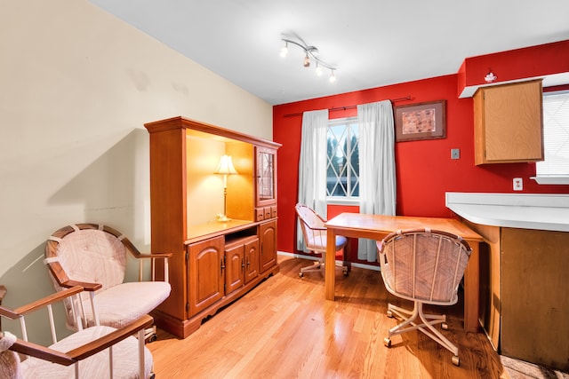 home office with light wood-style flooring