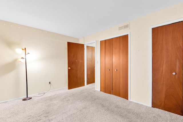 unfurnished bedroom featuring visible vents and carpet flooring