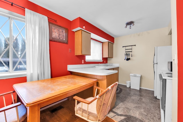 kitchen with light countertops, visible vents, and baseboards