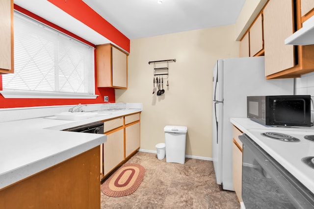 kitchen with light countertops, a sink, black appliances, under cabinet range hood, and baseboards