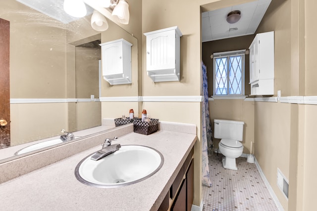 bathroom with baseboards, visible vents, toilet, tile patterned floors, and vanity