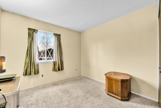 empty room with carpet and baseboards