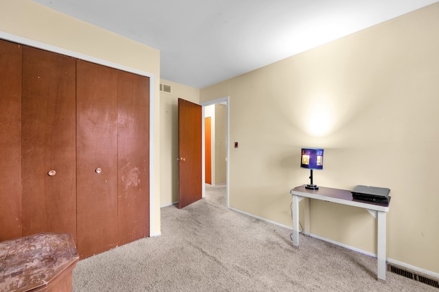 carpeted bedroom featuring visible vents and baseboards