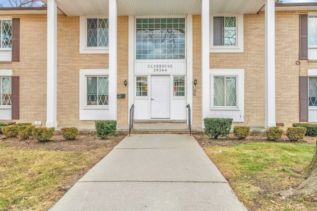 property entrance featuring brick siding