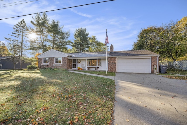 single story home featuring brick siding, a chimney, an attached garage, driveway, and a front lawn