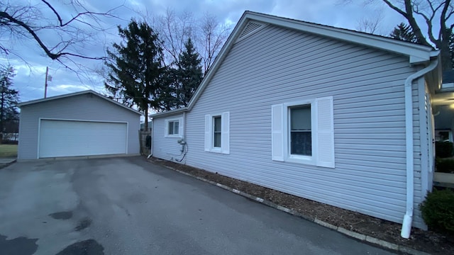 view of side of home with a garage and an outdoor structure