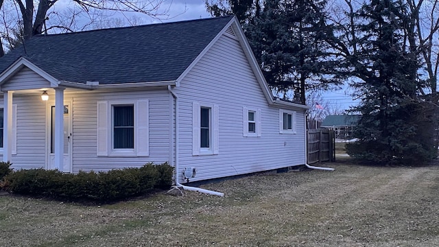 view of property exterior with a shingled roof