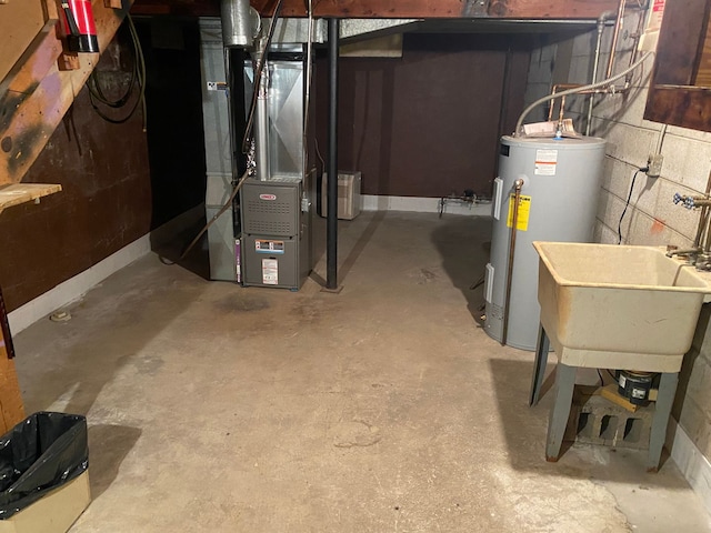 utility room with water heater, a sink, and heating unit