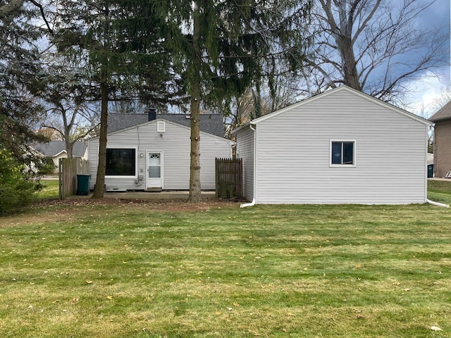 rear view of property with a yard