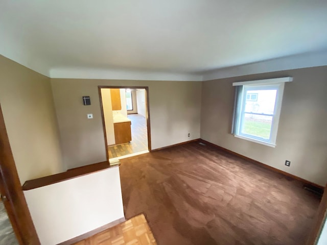 unfurnished room featuring baseboards