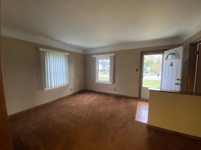 interior space featuring carpet and baseboards