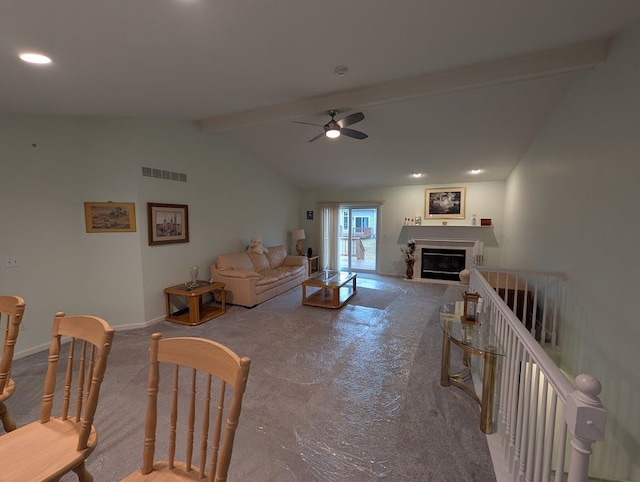 living area featuring vaulted ceiling with beams, visible vents, a ceiling fan, a glass covered fireplace, and baseboards