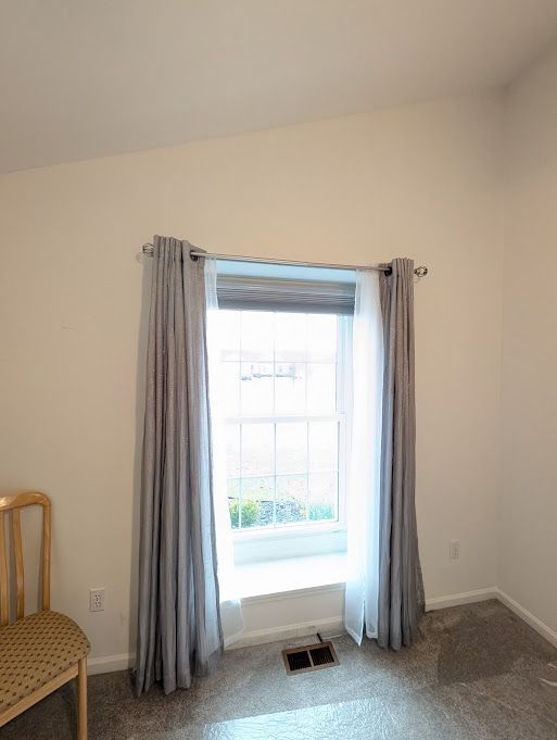 interior space with baseboards and visible vents