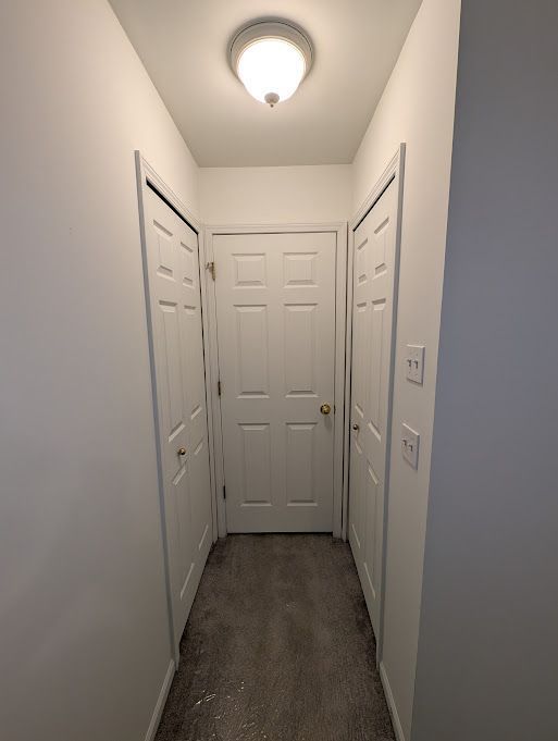 hall featuring baseboards