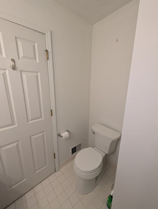 bathroom featuring toilet, tile patterned flooring, and visible vents