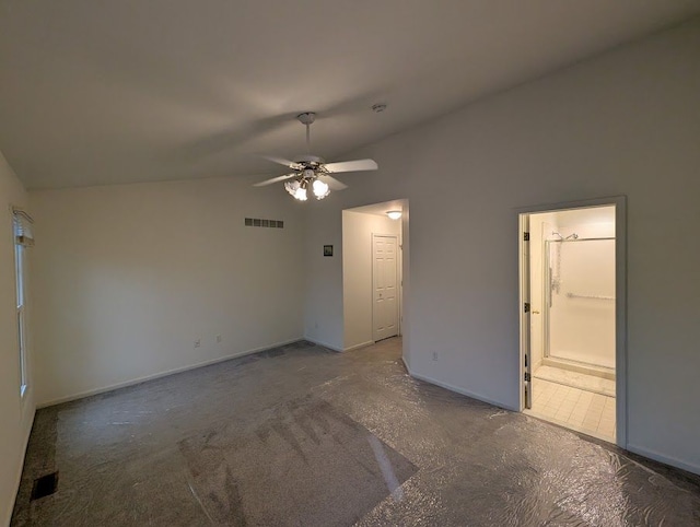 empty room with ceiling fan, visible vents, vaulted ceiling, and baseboards