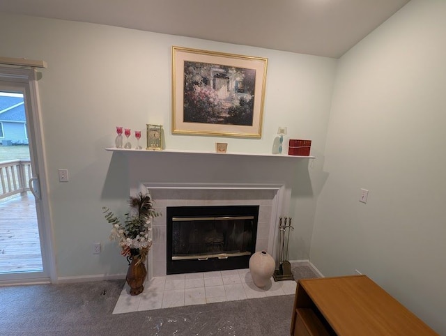 interior details featuring carpet, a tile fireplace, and baseboards