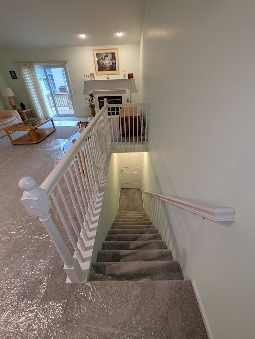 stairs featuring a fireplace and baseboards