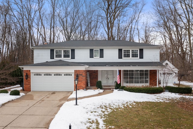 traditional-style house with brick siding, driveway, and an attached garage