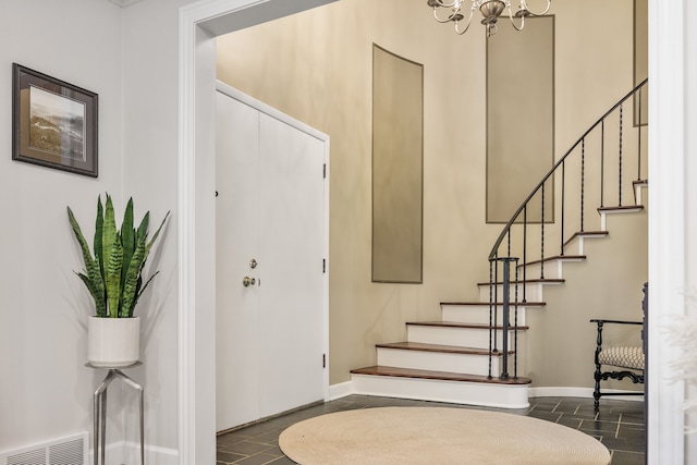 entryway with stairs, visible vents, and baseboards