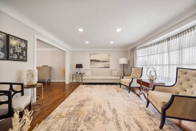 sitting room with baseboards, dark wood finished floors, and recessed lighting