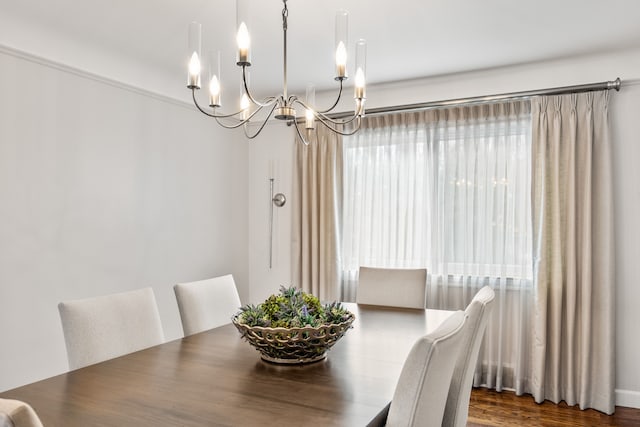 dining area with a notable chandelier and wood finished floors