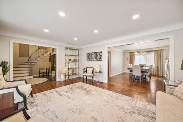 living area featuring a chandelier, stairway, wood finished floors, and recessed lighting