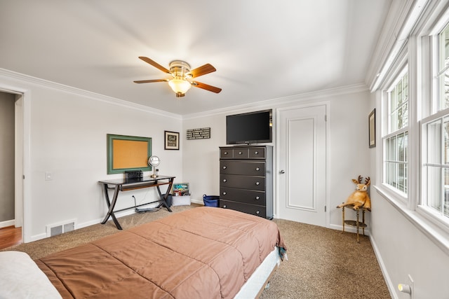 bedroom featuring carpet floors, a ceiling fan, baseboards, visible vents, and crown molding