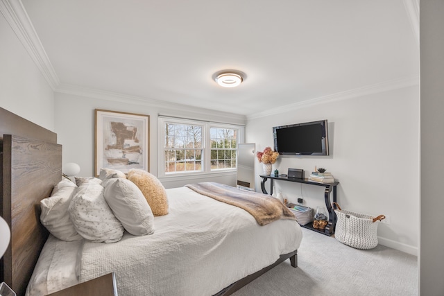 carpeted bedroom featuring ornamental molding and baseboards