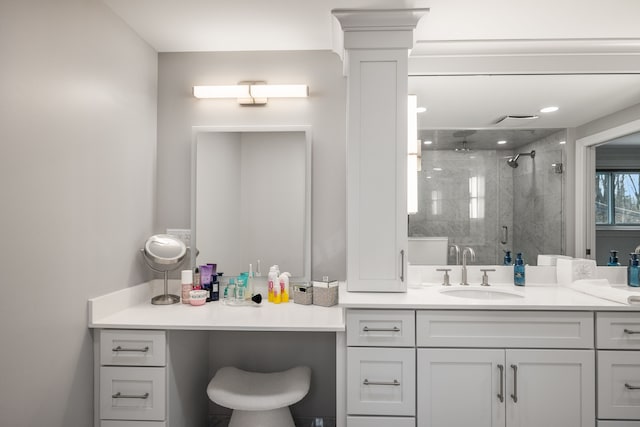 full bath with a stall shower, vanity, and ornate columns