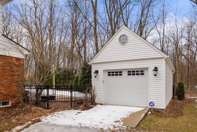 detached garage featuring fence