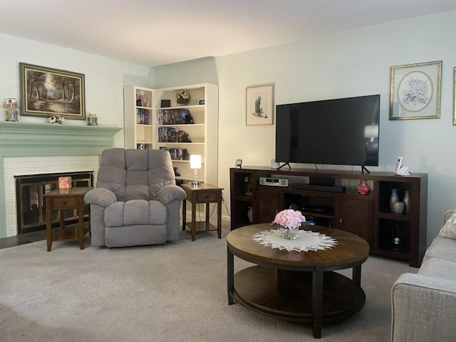 carpeted living area with a brick fireplace