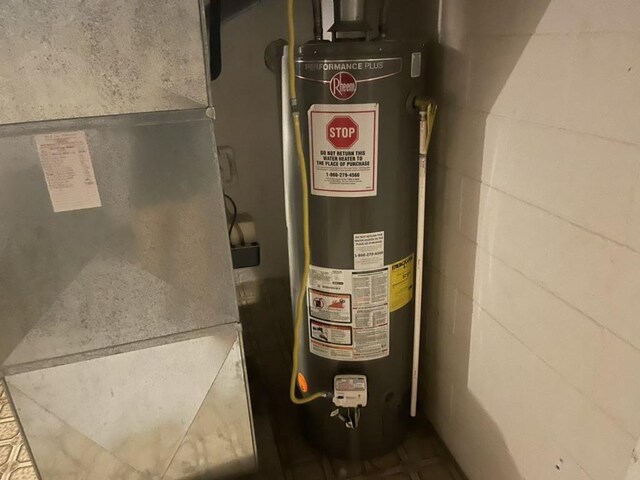 utility room with water heater and heating unit