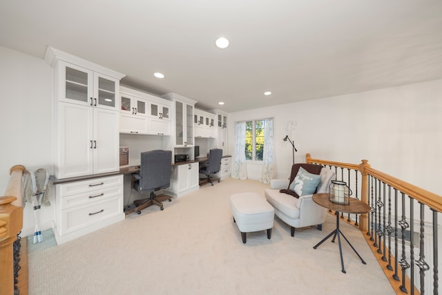 office featuring recessed lighting, light carpet, and built in desk