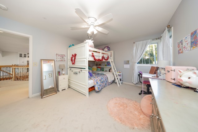 bedroom featuring light carpet, ceiling fan, and baseboards