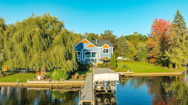 dock area with a water view and a lawn